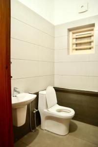 a bathroom with a toilet and a sink at Choice Beach House in Kannur