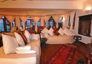 a living room with two white couches and windows at Zi Villa Main House in Matemwe
