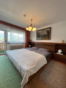 a bedroom with a large bed and a large window at Apartment „Bergblick“ in Sankt Johann in Tirol
