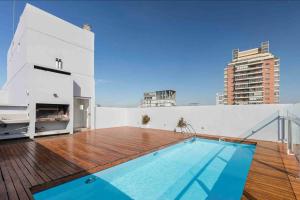 a balcony with a swimming pool on top of a building at Núñez Minimal Apartment Premium in Buenos Aires