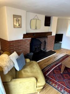 a living room with a couch and a fireplace at Bay Tree Barn in Truro