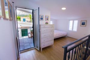 a bedroom with a dresser and a sliding glass door at Apartments Baška in Baška