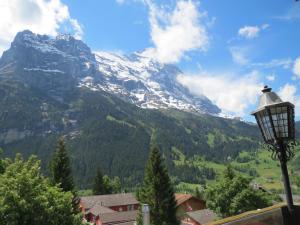 a street light with a mountain in the background at Bernerhof Residence in Grindelwald