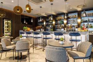 a bar with tables and chairs in a restaurant at Ultra Marine by Zdrojowa in Kołobrzeg