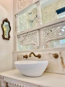 a bathroom with a white bowl sink on a counter at The Mill House on the Brooks South Downs West Sussex Sleeps 15 in Hardham