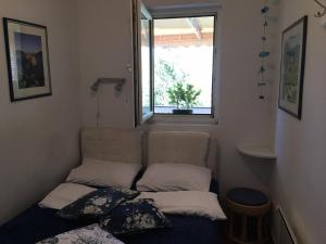 a small room with a couch and a window at Apartment Simo in Herceg-Novi