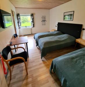 En eller flere senge i et værelse på Nordgården Pension