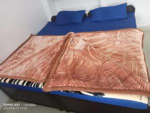 a bed with a blanket on top of it at Hotel Shri Kedar Mangalam By StayApart in Phata