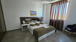 a bedroom with a large bed and a window at Dorana Residence in Geunyeli