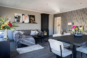 a living room with a table and a couch at Mart9 City Loft in Zevenbergen