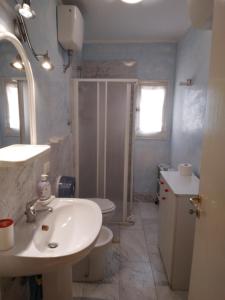 a bathroom with a sink and a shower and a toilet at FORESTERIA DEL TEATRO in Agrigento