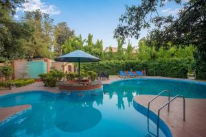 Kolam renang di atau dekat dengan StayVista at Estate 10 by Tarika - Luxury 4BR with Outdoor Pool and Lawn, ideal of events in Delhi