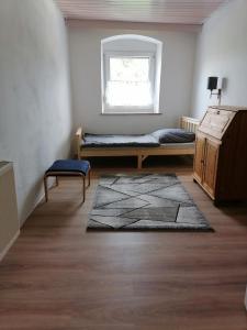 a room with a bed and a window and a rug at Naab-burg in Nabburg