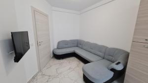 a living room with a couch and a tv at NORDIC Residence 46 in Suceava +2 photos