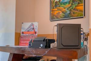 a television sitting on top of a wooden table at Urbanview Hotel AVA Banjarmasin by RedDoorz in Banjarmasin