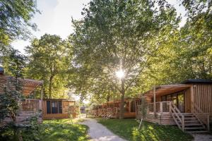 a row of lodges in a forest with trees at CityKamp Paris in Paris +42 photos