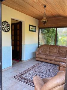 uma sala de estar com um sofá e uma porta em Cottage à La Torche em Plomeur
