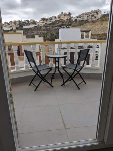 a table and two chairs on a balcony at Buena Vista Golf, Ciudad Quesada in Ciudad Quesada