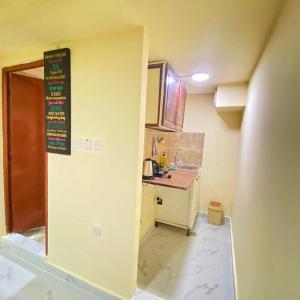 une petite cuisine avec évier et comptoir dans l'établissement King bed-Studio Room Near "al bateen" Abudhabi, à Abu Dhabi