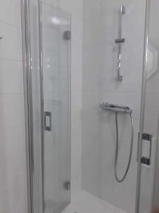 a shower in a bathroom with a glass shower stall at Les Tilleuls in Ballan-Miré