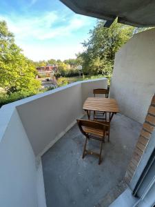 a patio with a table and chairs on a balcony at !NEW! Disney/Paris - 50m RER A in Noisy-le-Grand