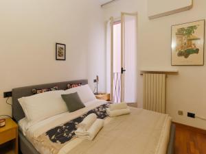a bedroom with a large bed with two towels on it at The Best Rent - Modern apartment in the center in Milan