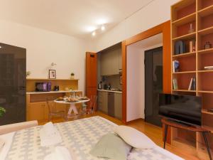 a living room with a table and a kitchen at The Best Rent - Modern apartment in the center in Milan
