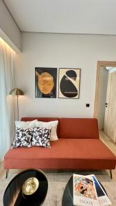 a living room with a red couch and a table at Jack, 2 people, renovated stylish apartment in Athens