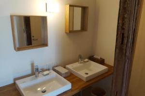 a bathroom with two sinks and a mirror at 離島-宿navelの学校-三原港から船で14分 in Mihara