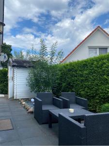 a patio with two chairs and a table and a building at FH Harmonie in Kaltenhof