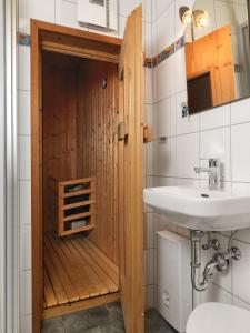 a bathroom with a toilet and a sink at Haus Sonneneck in Kaltenhof