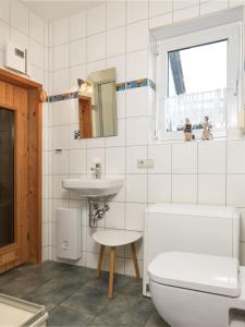 a bathroom with a toilet and a sink at Haus Sonneneck in Kaltenhof
