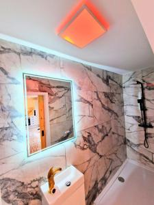 a bathroom with a sink and a mirror at Kaoglen Buck Pod - Hot Tub - Feature - Pets in Blairgowrie