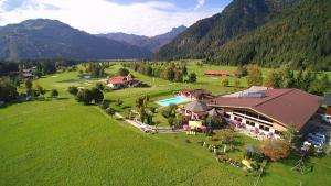 an aerial view of a resort with a pool and mountains at Gut Hanneshof in Erpfendorf