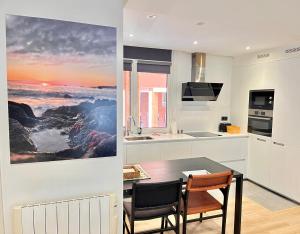 a kitchen and dining room with a table and chairs at SMALL LUX BEACHCITY close to METRO in Bilbao