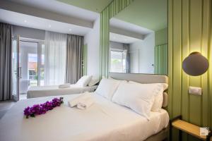 a bedroom with a large bed with purple flowers on it at Villaggio Baia D'Ercole in Capo Vaticano +72 photos