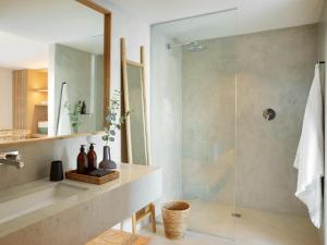 a bathroom with a glass shower and a sink at Walkers Beach in Plettenberg Bay +16 photos