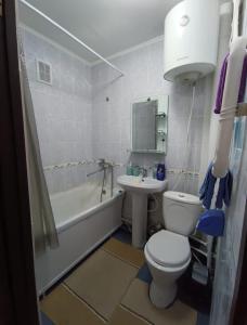 a bathroom with a toilet and a sink at Квартира LUX, Lux apartment in Taraz