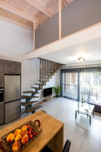 a kitchen and living room with a bowl of fruit on a table at Villa Artemis A&B in Chania Town