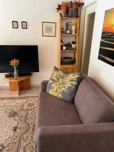a living room with a couch and a flat screen tv at Fortuna 403 in Leukerbad