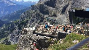 a group of people standing on a viewing platform at the top of a mountain at Fortuna 403 in Leukerbad