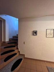 a staircase in a building with black and white pictures on the wall at Zimmer Nähe Darmstadt in Roßdorf