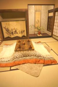 ein Bett mit einem Holztisch in einem Zimmer in der Unterkunft Aioi Yanto 一日一組限定古民家宿 in Otaru