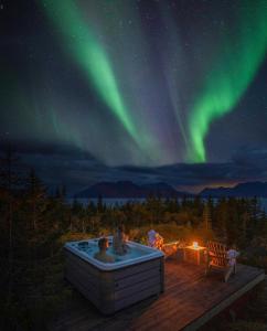 a soak in a hot tub under the northern lights at WonderInn Arctic in Utstrand