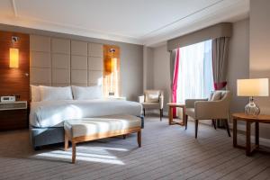 a hotel room with a bed and a chair at Hilton Cambridge City Centre in Cambridge +96 photos