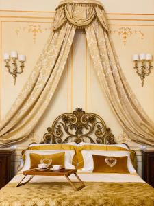 a bedroom with a king sized bed with a canopy at Palazzo Lari Luxury Accommodation in Sarzana