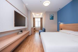 Postel nebo postele na pokoji v ubytování Future Shangju Hotel