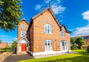 an old brick house with a red door at Supersized Studio in Chester in Chester