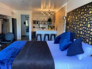 a bedroom with a large bed with blue pillows at Beach House in Yeppoon