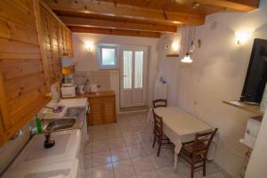 a kitchen with a sink and a table with a tableablish at Apartment in Veli Losinj 26456 in Veli Lošinj
